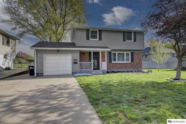 view of front facade with an attached garage, a front lawn, brick siding, covered porch, and driveway