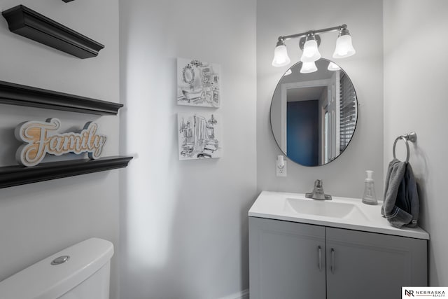 half bath featuring toilet and vanity