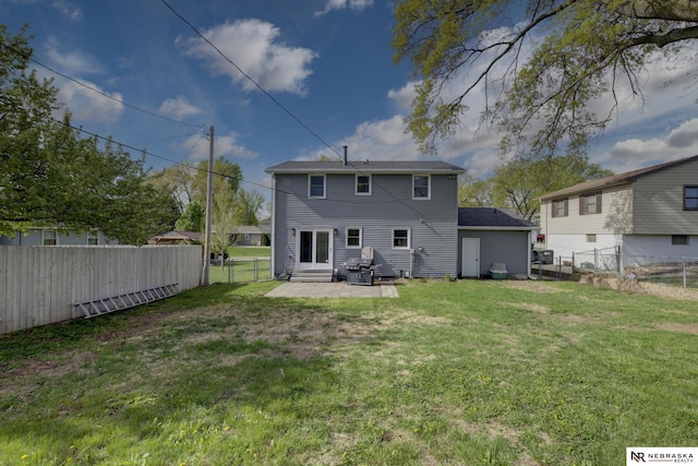 back of property featuring a lawn, a patio, and a fenced backyard