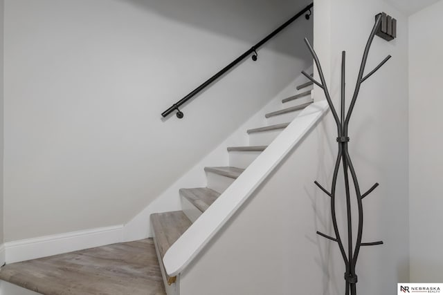 stairway featuring wood finished floors