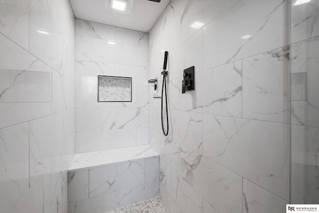 bathroom featuring a tile shower