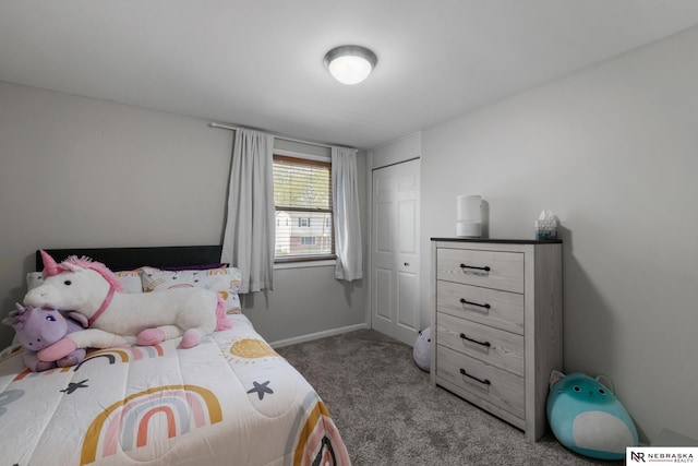 bedroom with a closet, carpet flooring, and baseboards