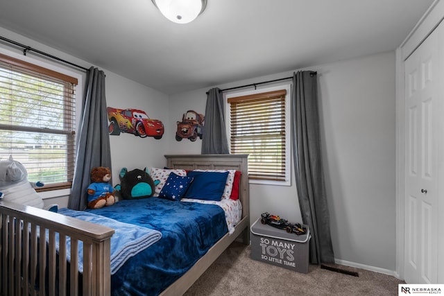 bedroom featuring a closet, carpet, and baseboards