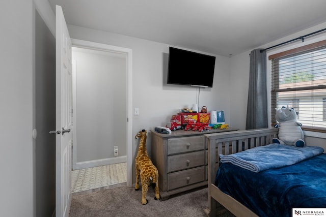 bedroom with baseboards and carpet