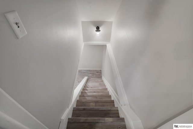 stairway with baseboards and wood finished floors
