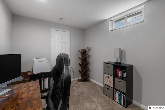 office area with carpet flooring, baseboards, and visible vents