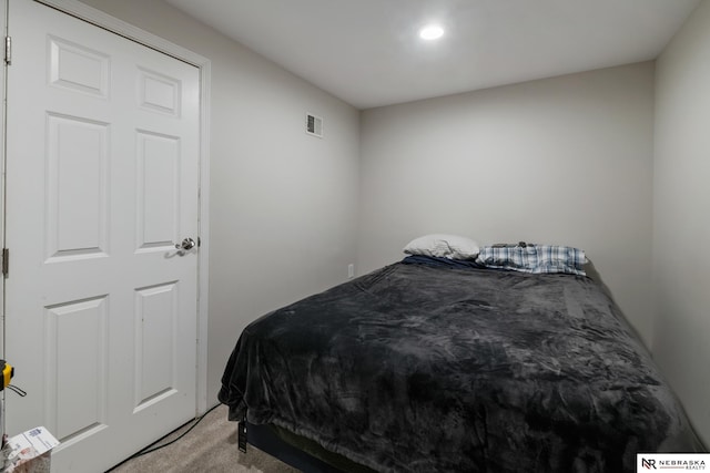 bedroom featuring recessed lighting, light colored carpet, and visible vents