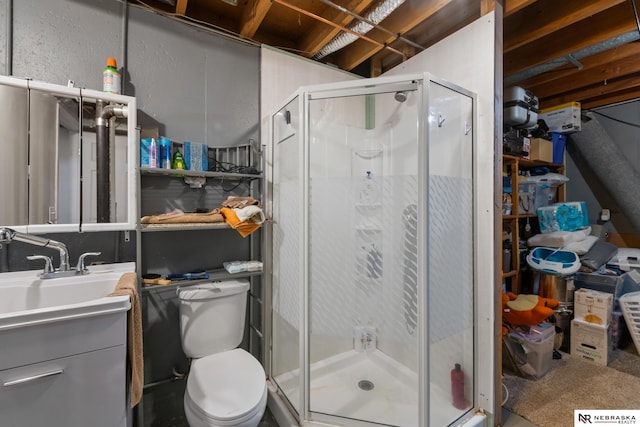 bathroom with vanity, a stall shower, and toilet