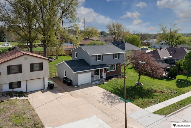 traditional-style house with a residential view, an attached garage, a shingled roof, and concrete driveway