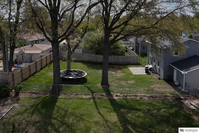 view of yard featuring fence and a residential view
