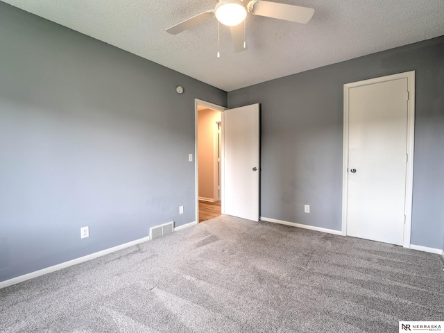 unfurnished bedroom with visible vents, baseboards, and carpet floors