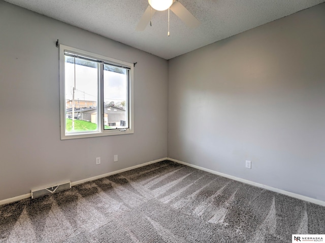 spare room with visible vents, baseboards, ceiling fan, a textured ceiling, and carpet flooring