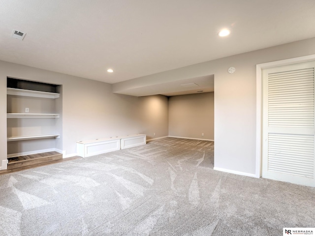 basement featuring recessed lighting, baseboards, visible vents, and light carpet