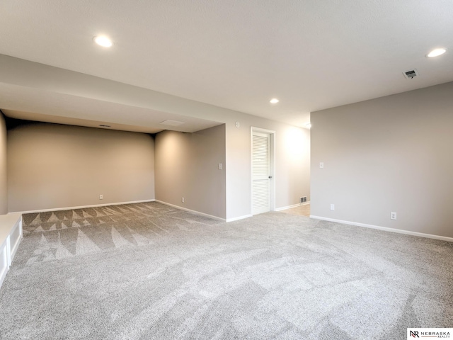 finished basement featuring visible vents, carpet flooring, baseboards, and recessed lighting
