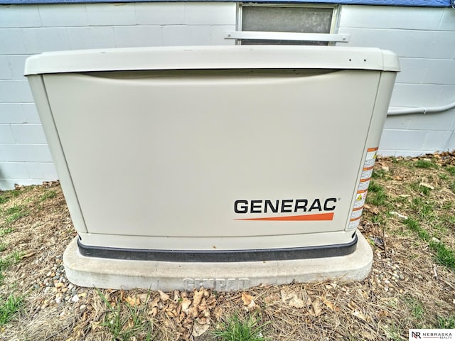 details featuring a power unit and concrete block siding