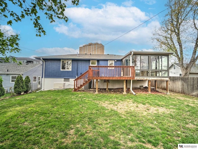 back of house with a wooden deck, a sunroom, stairway, fence, and a yard