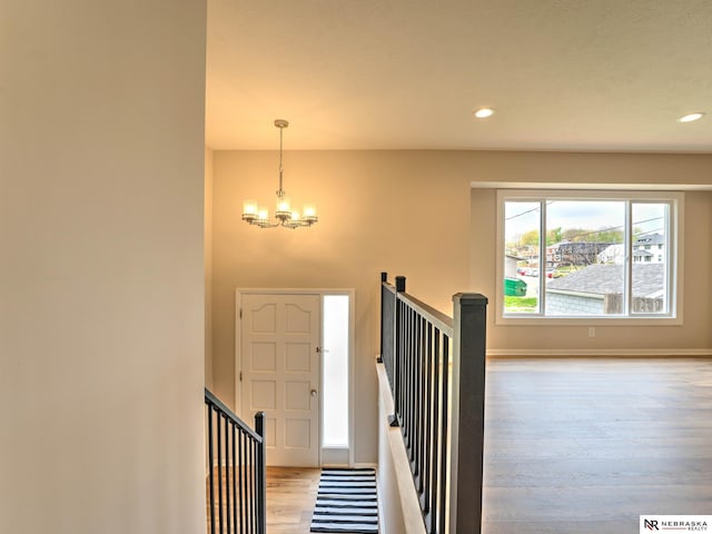 entryway with an inviting chandelier, recessed lighting, baseboards, and wood finished floors