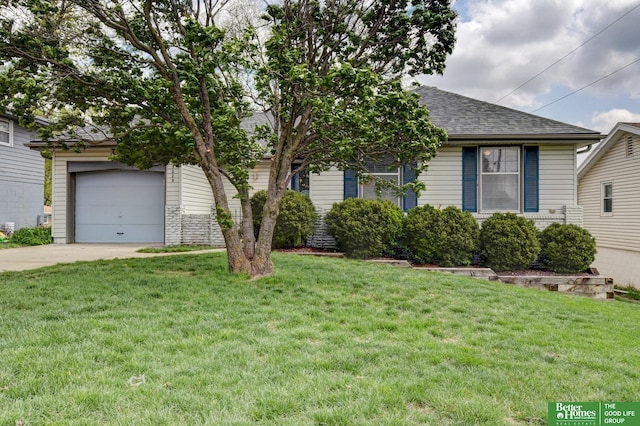 view of front of property with roof with shingles, an attached garage, concrete driveway, and a front yard