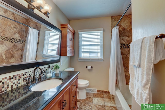bathroom with vanity, shower / bath combo with shower curtain, visible vents, toilet, and baseboards