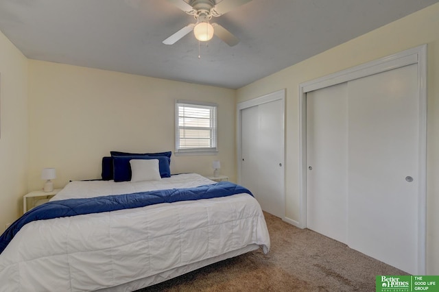 bedroom with carpet flooring, multiple closets, and ceiling fan