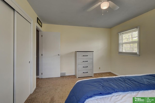 carpeted bedroom with a ceiling fan, baseboards, and visible vents
