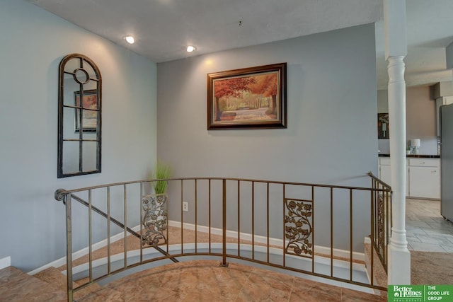 stairs featuring recessed lighting and stone finish floor
