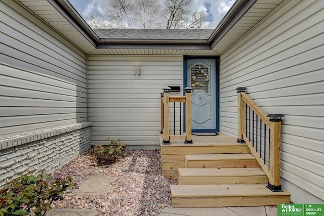 entrance to property with roof with shingles