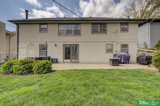 rear view of property featuring fence, central air condition unit, a yard, and a patio area