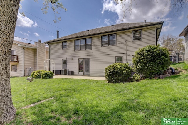 rear view of house with a lawn, a patio area, central air condition unit, and fence