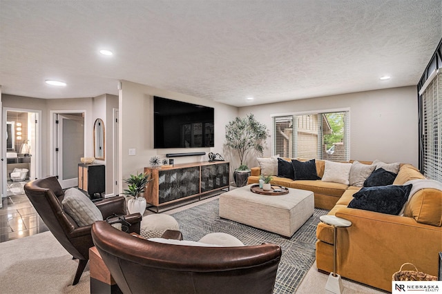 living area with recessed lighting and a textured ceiling