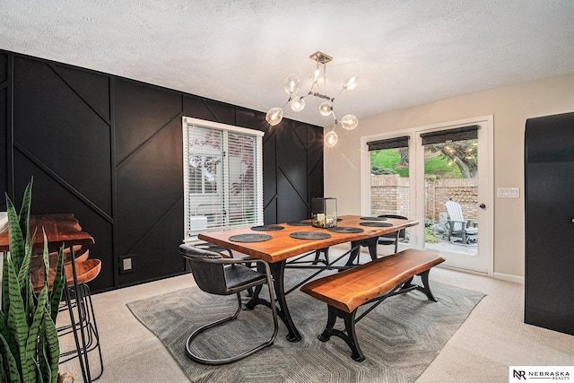 dining area with an inviting chandelier, baseboards, and light carpet
