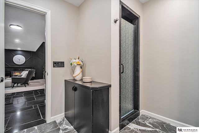 hall featuring baseboards and marble finish floor