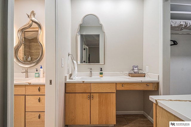 bathroom with a sink and two vanities