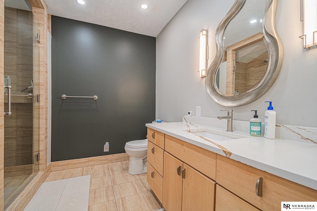 full bath with vanity, a stall shower, recessed lighting, and toilet