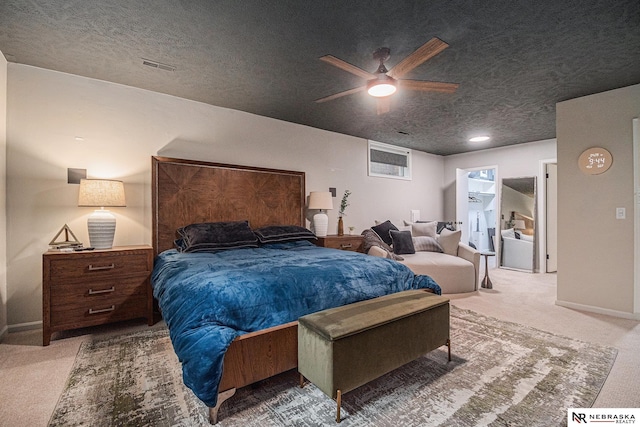 bedroom featuring carpet floors, a textured ceiling, baseboards, and visible vents