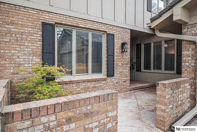 exterior space featuring brick siding and board and batten siding
