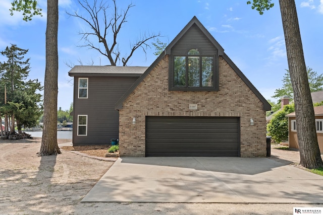 S-1007 Shady Ln, Fremont, NE 68025 - view of front facade with brick siding, concrete driveway, and an attached garage