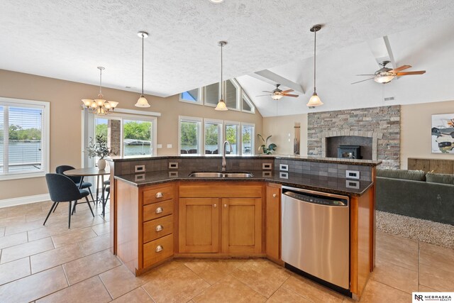 S-1007 Shady Ln, Fremont, NE 68025 - kitchen featuring dishwasher, a sink, open floor plan, pendant lighting, and lofted ceiling