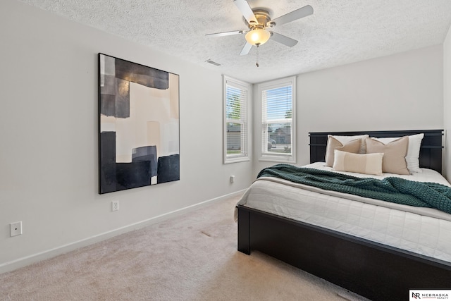 S-1007 Shady Ln, Fremont, NE 68025 - bedroom featuring carpet floors, baseboards, a textured ceiling, and a ceiling fan