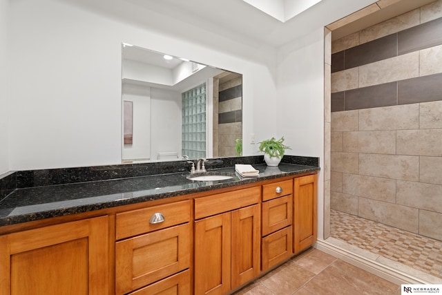 S-1007 Shady Ln, Fremont, NE 68025 - full bathroom with a tile shower, vanity, and tile patterned flooring