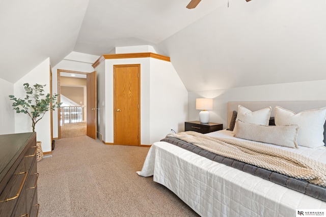 S-1007 Shady Ln, Fremont, NE 68025 - bedroom featuring vaulted ceiling, light carpet, and a ceiling fan