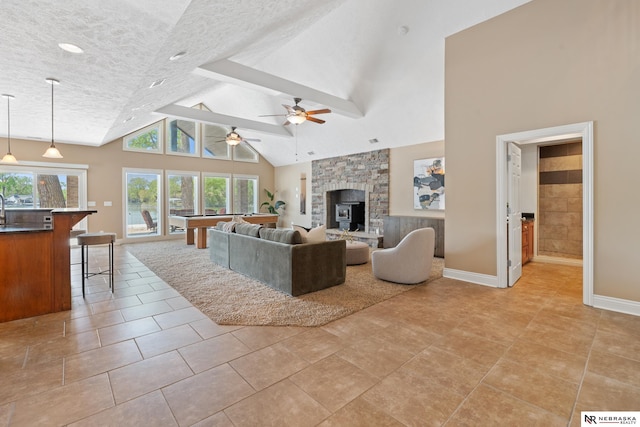 S-1007 Shady Ln, Fremont, NE 68025 - living area with ceiling fan, high vaulted ceiling, a textured ceiling, baseboards, and light tile patterned floors