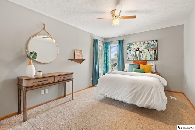 S-1007 Shady Ln, Fremont, NE 68025 - bedroom with carpet floors, a textured ceiling, baseboards, and a ceiling fan