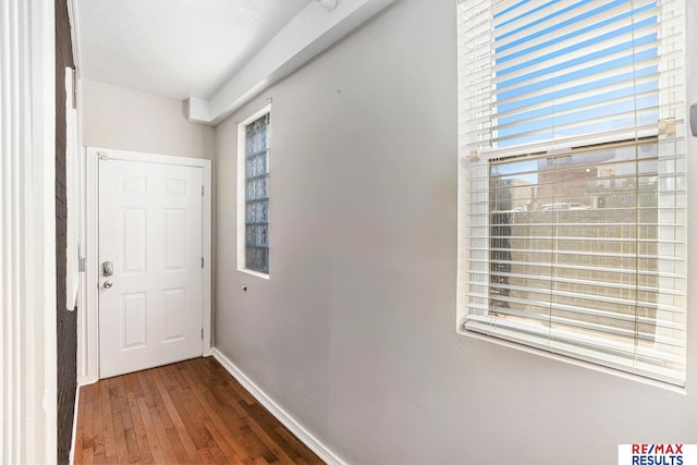 doorway to outside with baseboards and hardwood / wood-style flooring