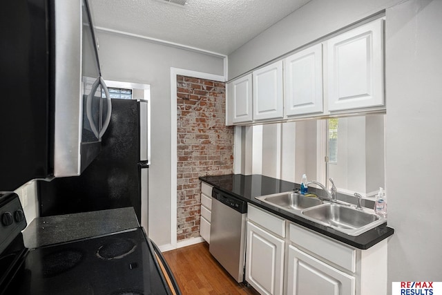 kitchen with electric range, a textured ceiling, white cabinetry, a sink, and dishwasher
