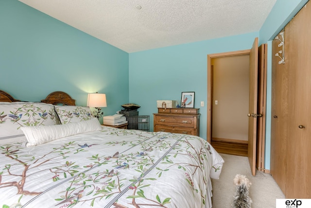 carpeted bedroom featuring a closet and a textured ceiling