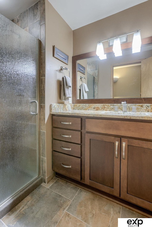 bathroom featuring a shower stall and vanity