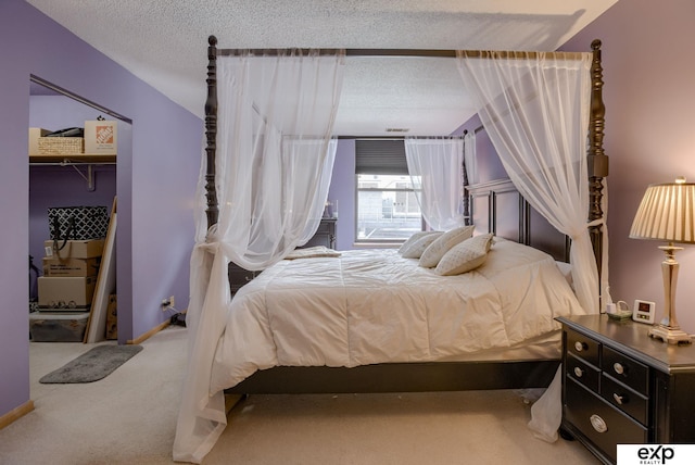 bedroom featuring a textured ceiling and carpet
