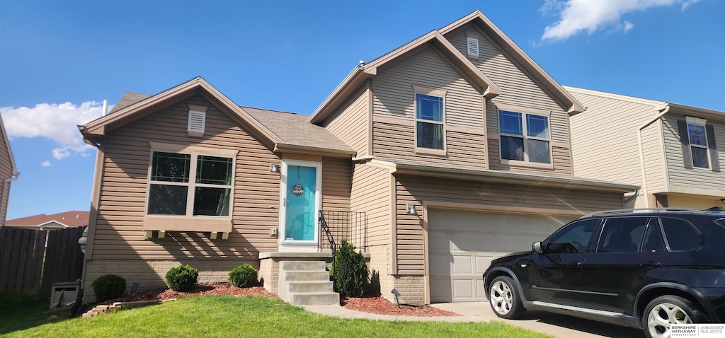 view of front facade with concrete driveway, fence, a front yard, and a garage