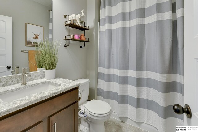 full bathroom with vanity, tile patterned floors, curtained shower, and toilet